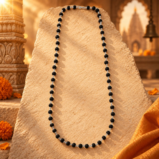 Karungali Mala with Silver-Plated Chain on warm sandstone